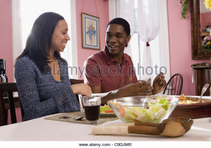 cheerful-brother-and-sister-sitting-at-dining-table-c9djmr