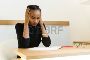 57472017-worried-thoughtful-african-or-black-american-businesswoman-holding-her-pretty-face-with-hands-closin