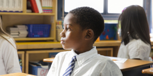 African-American School Boy Sitting at Desk